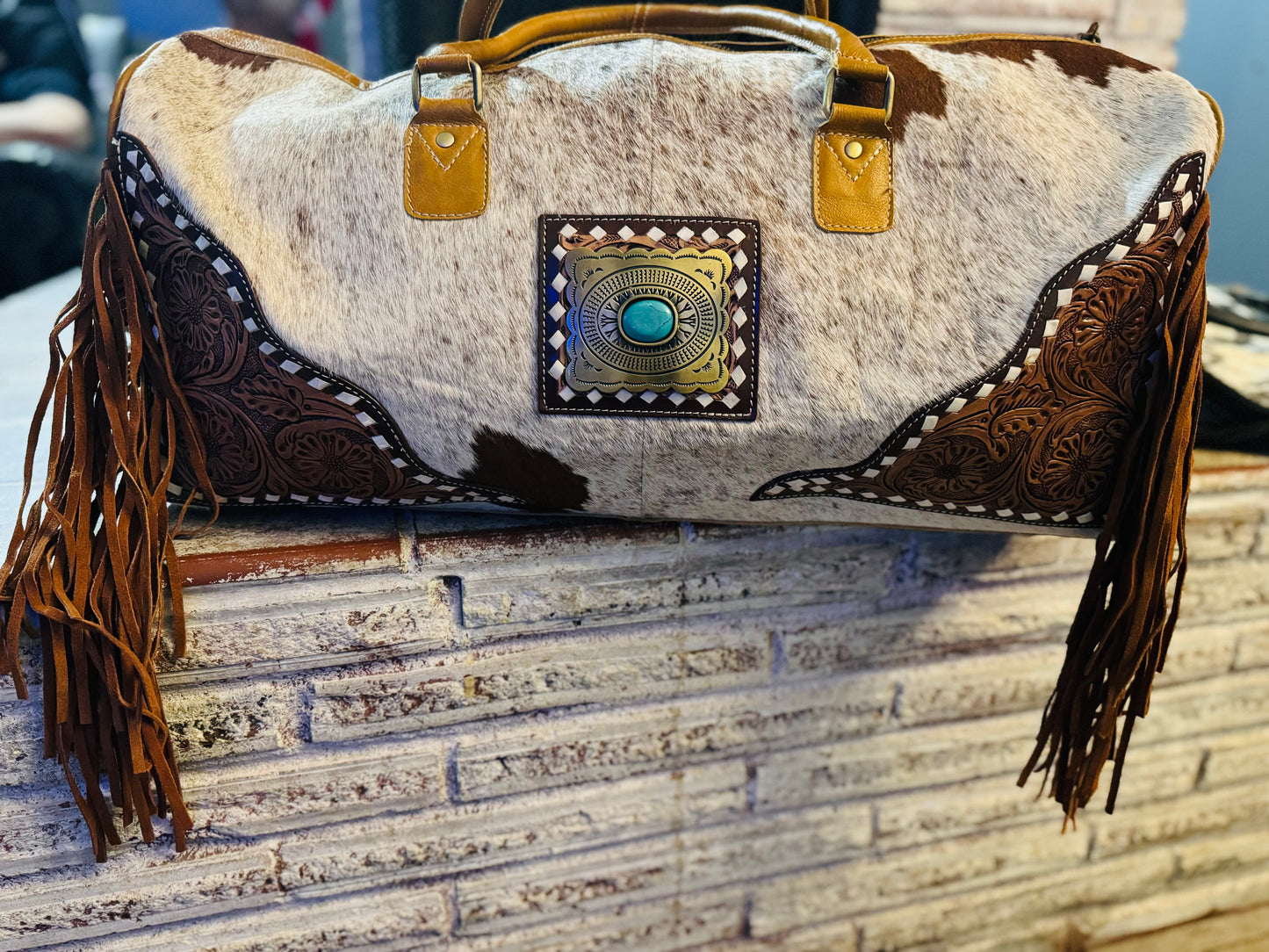 Tooled cowhide fringe duffle bag
